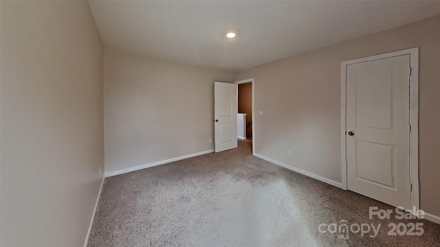 unfurnished room with baseboards