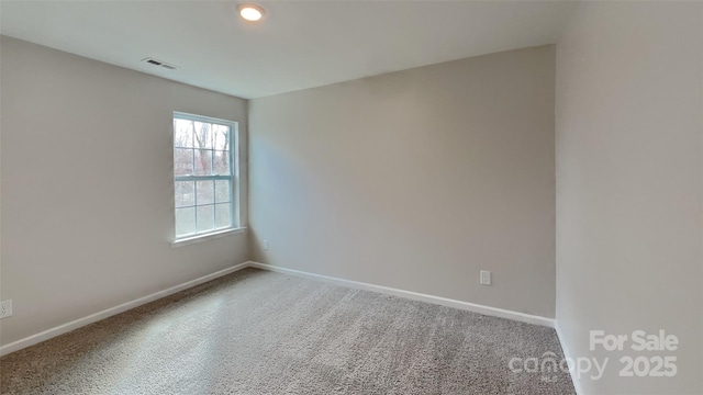 unfurnished room with visible vents and baseboards