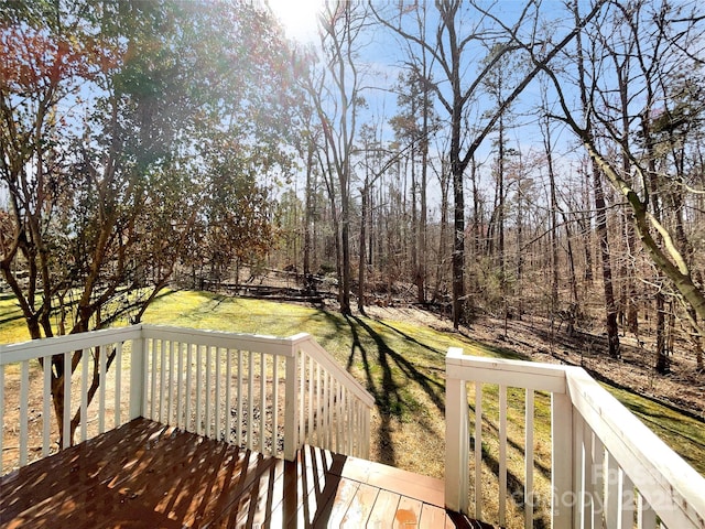 wooden deck featuring a yard