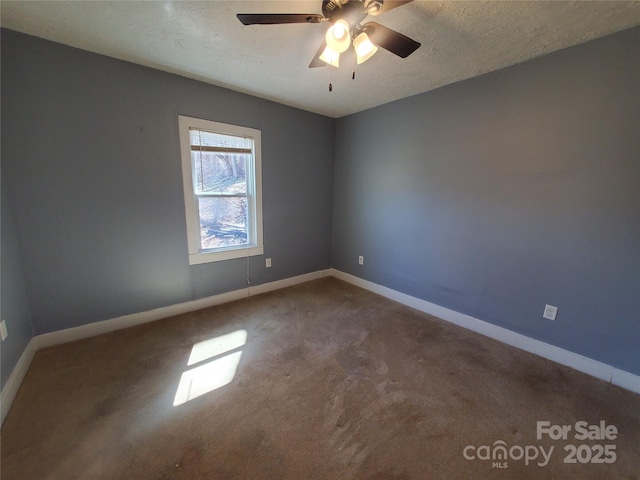 carpeted empty room featuring a textured ceiling and baseboards