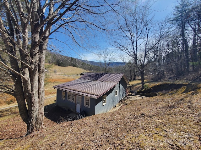 view of side of home with metal roof