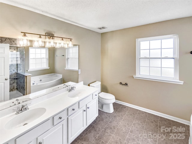 bathroom featuring visible vents, a sink, a shower stall, and a garden tub