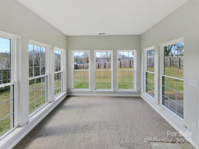 unfurnished sunroom with a wealth of natural light and visible vents