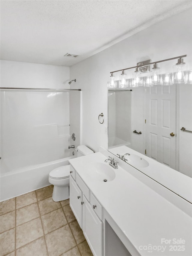 full bath featuring a textured ceiling, toilet, visible vents, vanity, and washtub / shower combination