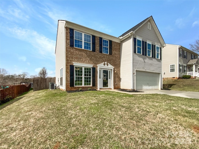 traditional-style home featuring an attached garage, driveway, a front yard, and fence