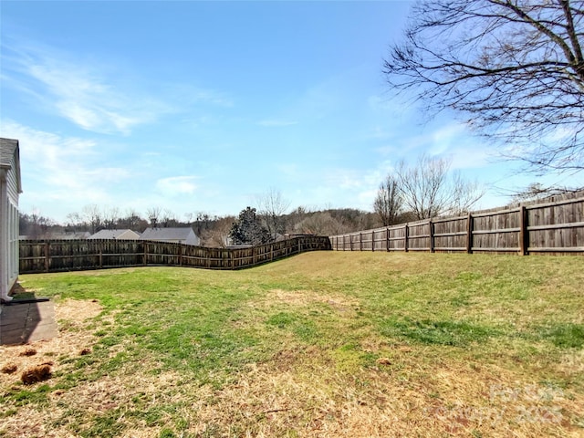 view of yard with a fenced backyard