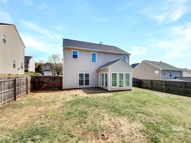 rear view of property with a yard, a fenced backyard, and a residential view