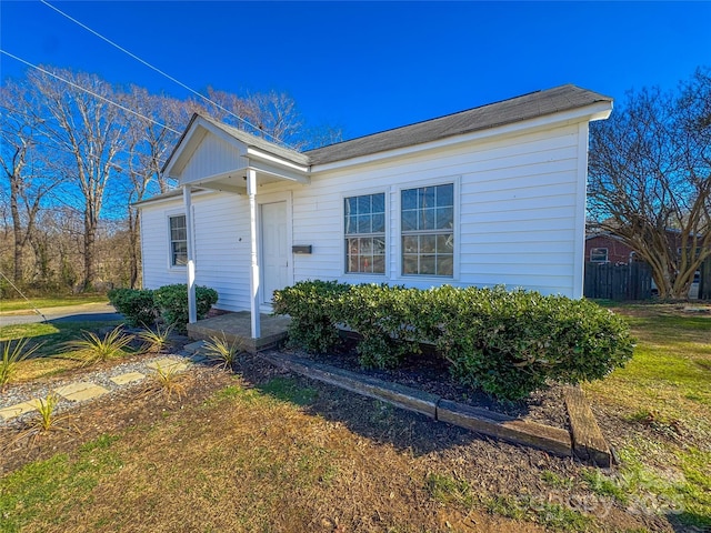 view of front of house with a front yard and fence