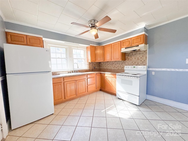 kitchen featuring light tile patterned floors, under cabinet range hood, white appliances, a sink, and light countertops