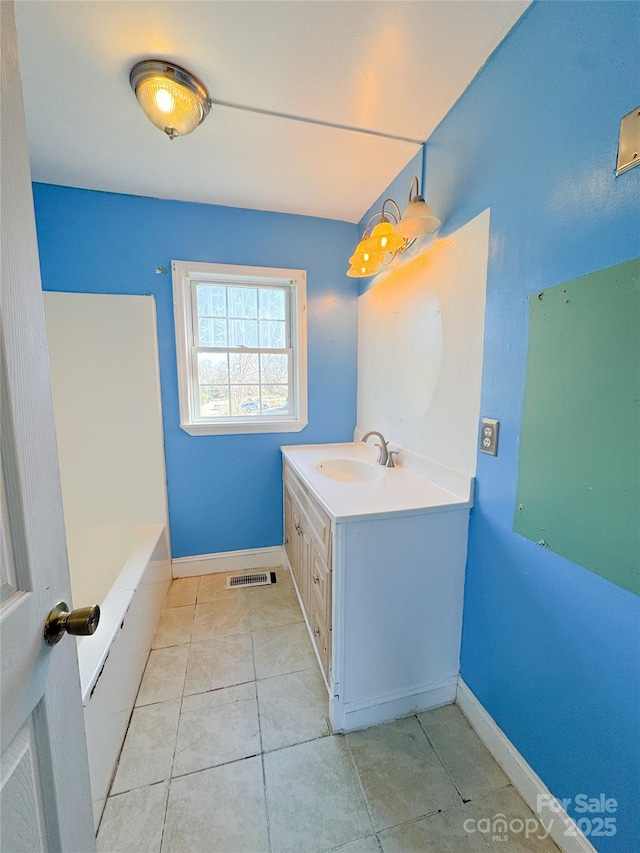 bathroom featuring tile patterned flooring, visible vents, vanity, and baseboards