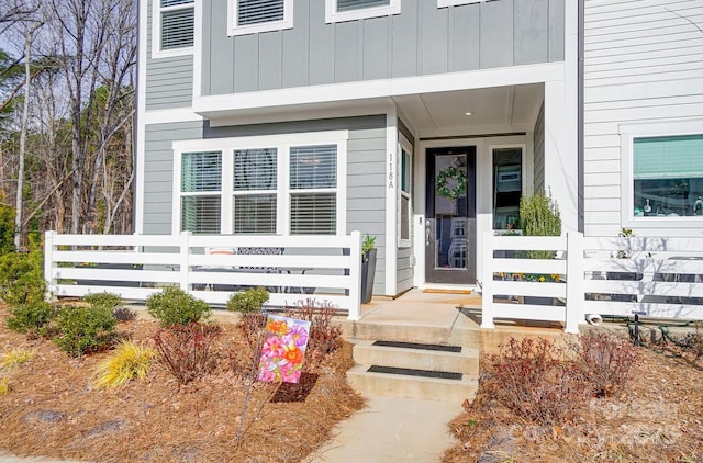 doorway to property featuring covered porch and board and batten siding