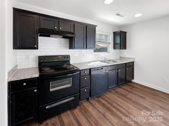 kitchen featuring dishwasher, black range with electric stovetop, dark wood-type flooring, under cabinet range hood, and a sink