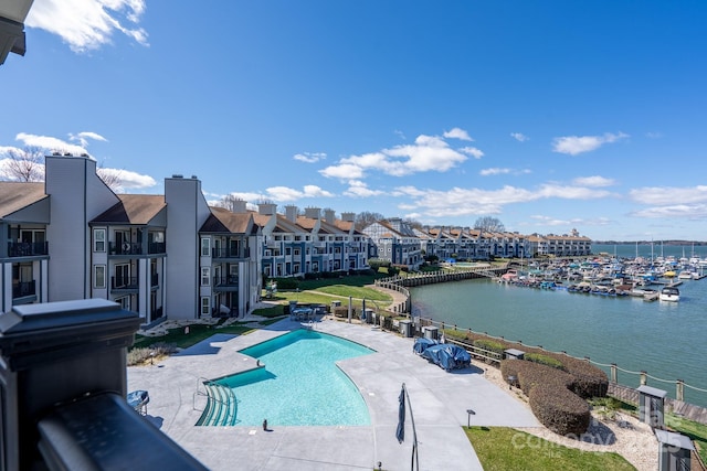 community pool featuring a patio area and a water view