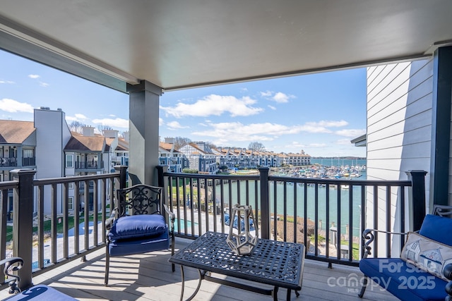 balcony with a water view and a residential view