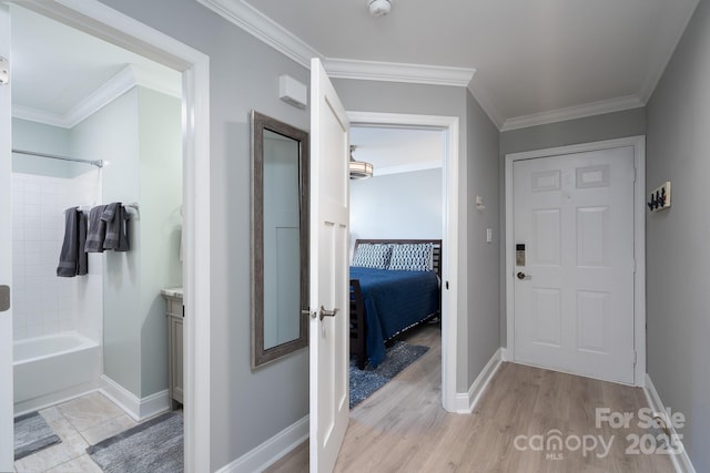 full bathroom with baseboards, wood finished floors, and crown molding