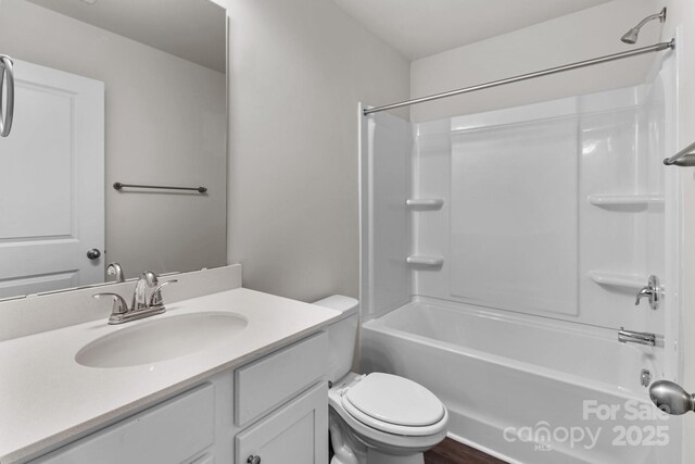 bathroom featuring shower / tub combination, vanity, and toilet