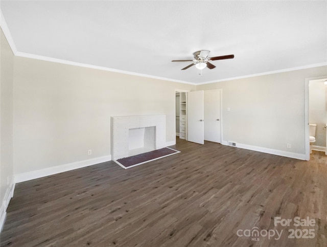 unfurnished living room with crown molding, a fireplace, baseboards, and dark wood-style flooring