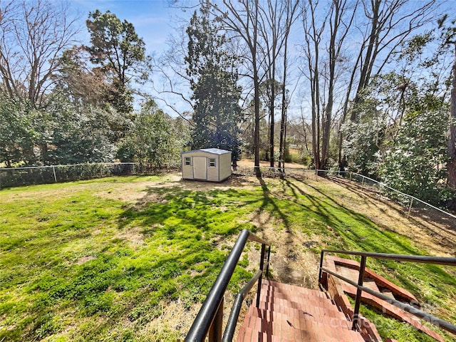 view of yard with a shed, an outdoor structure, and a fenced backyard