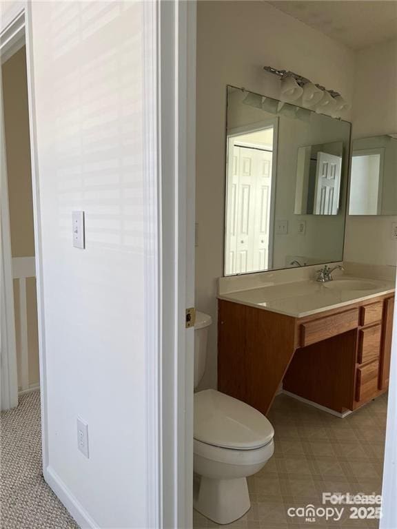 bathroom with vanity, tile patterned floors, and toilet