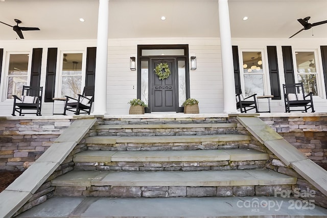 entrance to property with covered porch and ceiling fan