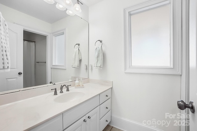 bathroom featuring vanity and baseboards