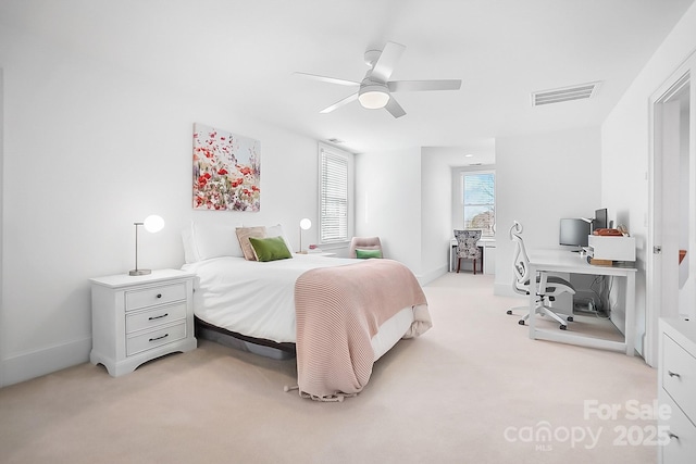 bedroom with visible vents, light colored carpet, baseboards, and a ceiling fan