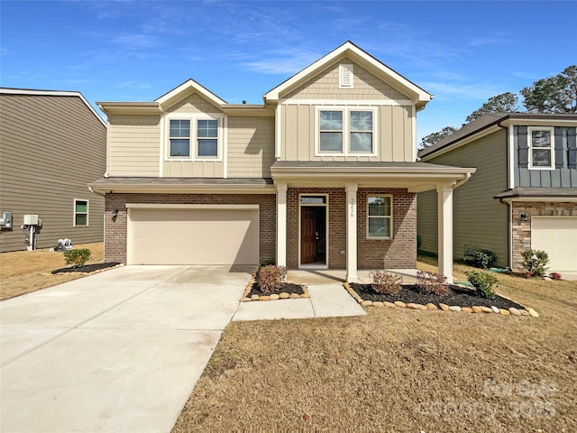 craftsman inspired home with an attached garage, brick siding, board and batten siding, and concrete driveway