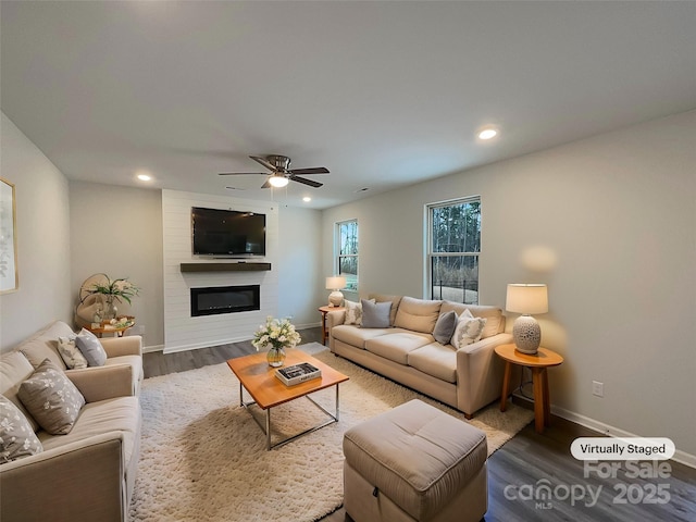 living area featuring recessed lighting, a fireplace, wood finished floors, a ceiling fan, and baseboards