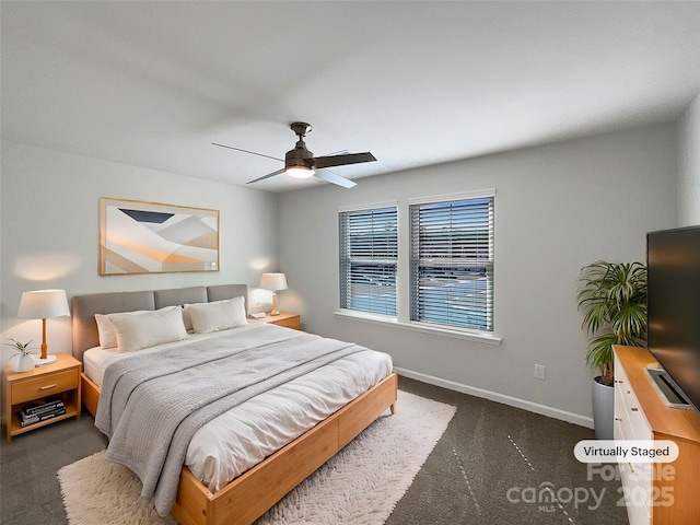 bedroom with dark colored carpet, ceiling fan, and baseboards