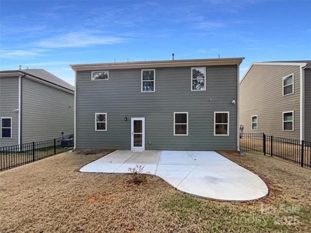 back of house featuring a fenced backyard, a lawn, and a patio