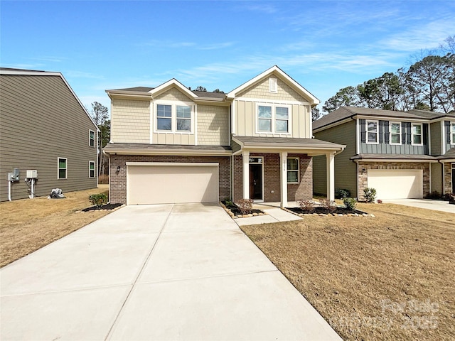 craftsman house with a garage, driveway, brick siding, and board and batten siding