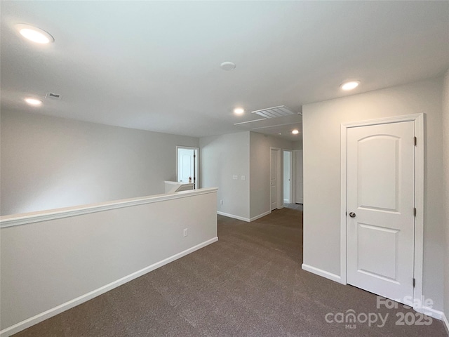 unfurnished room featuring visible vents, baseboards, dark colored carpet, and recessed lighting