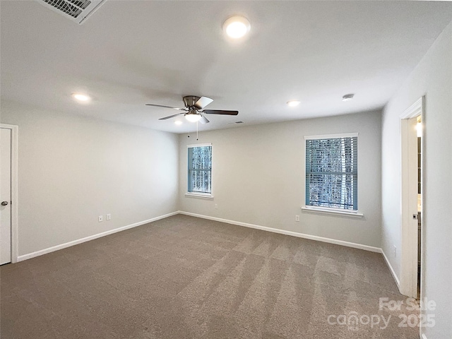 spare room with recessed lighting, a ceiling fan, visible vents, baseboards, and dark colored carpet