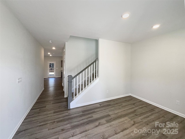 interior space with stairs, baseboards, dark wood-style flooring, and recessed lighting