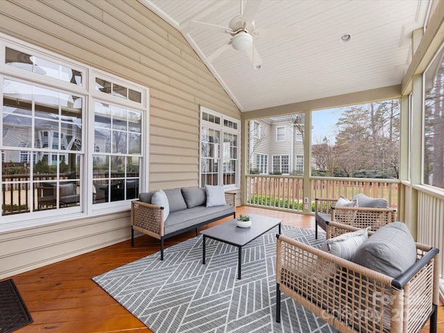 sunroom / solarium with lofted ceiling and a ceiling fan