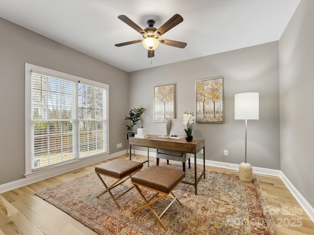 office area with visible vents, baseboards, wood finished floors, and a ceiling fan