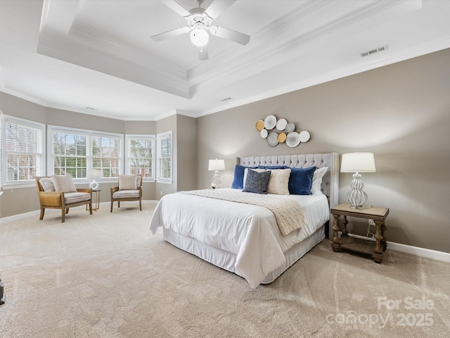 bedroom with visible vents, baseboards, a tray ceiling, and carpet