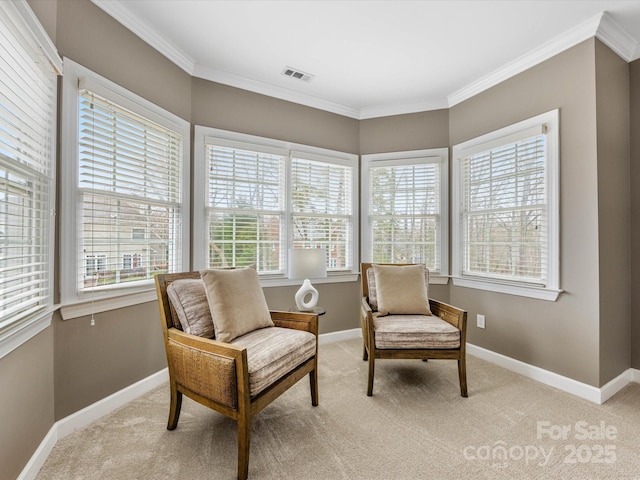 sitting room with ornamental molding, light colored carpet, visible vents, and baseboards