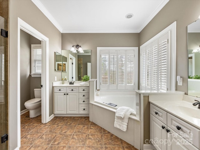 bathroom with two vanities, ornamental molding, a sink, a garden tub, and toilet