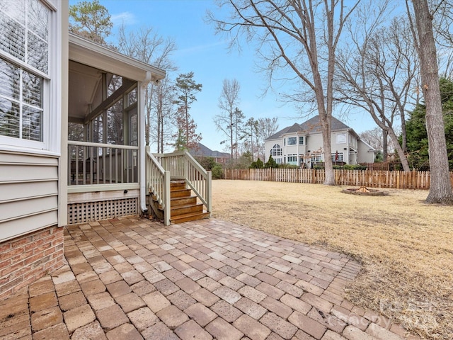 view of patio / terrace with fence private yard and a sunroom