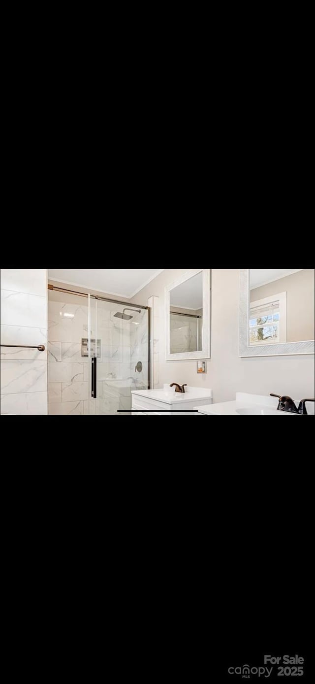 bathroom with a stall shower and vanity