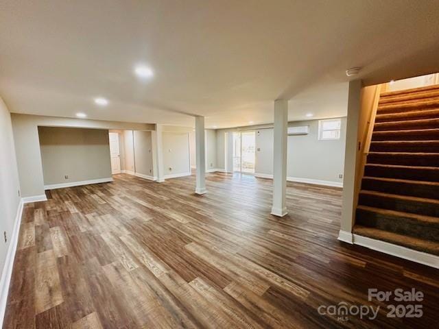below grade area featuring recessed lighting, stairway, baseboards, and dark wood-type flooring