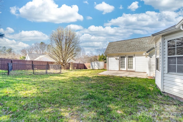 view of yard featuring an outbuilding, a fenced backyard, a patio, and a shed