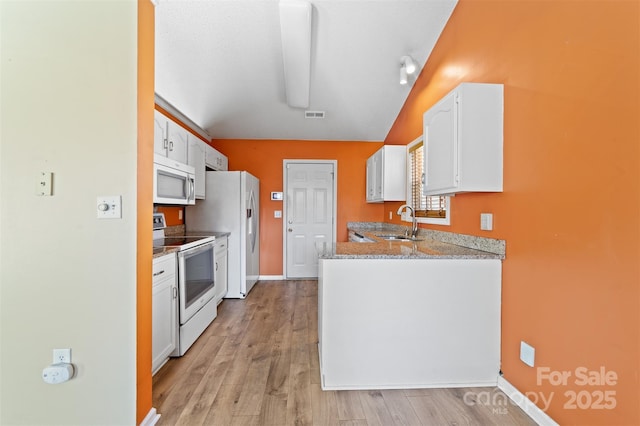 kitchen with white appliances, visible vents, light wood-style flooring, white cabinetry, and a sink