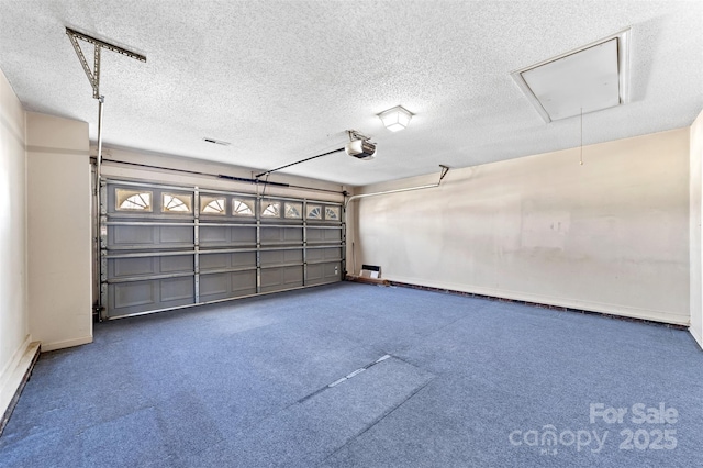 garage with a baseboard heating unit and a garage door opener