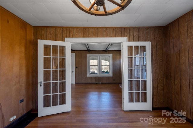 interior space featuring wood walls, visible vents, and wood finished floors