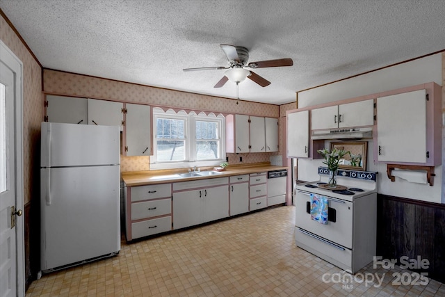 kitchen with wallpapered walls, white range with electric stovetop, dishwasher, freestanding refrigerator, and light floors