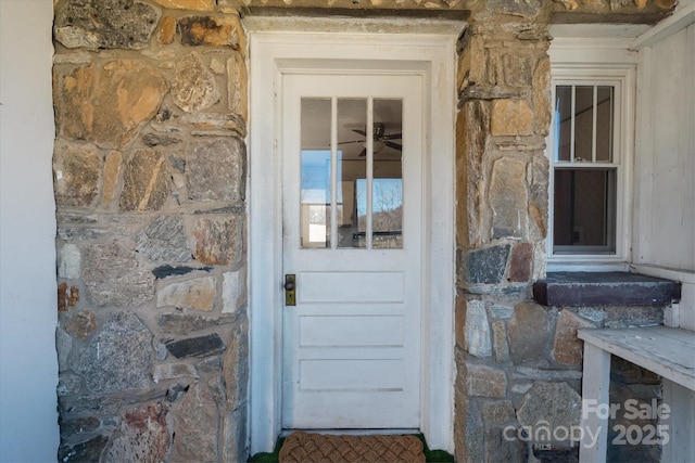 doorway to property featuring stone siding