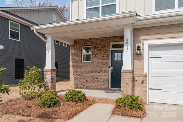 entrance to property with brick siding, board and batten siding, and a porch