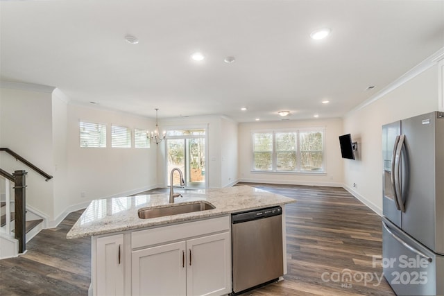 kitchen featuring stainless steel appliances, a sink, white cabinets, and crown molding